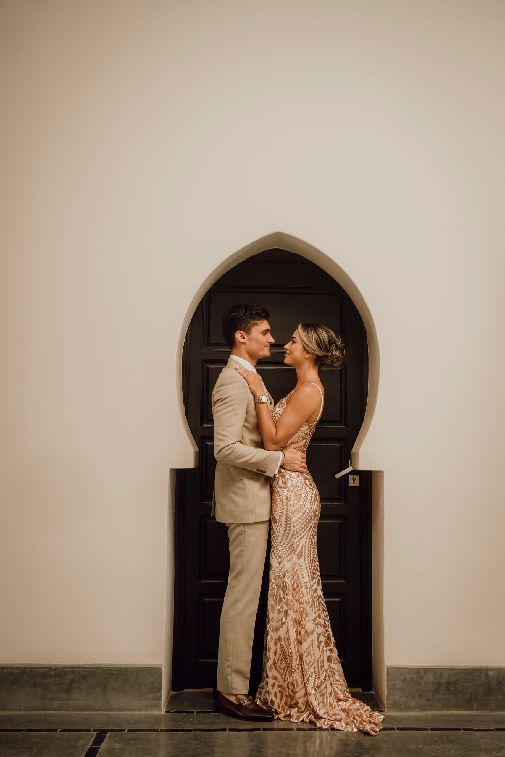 A couple framed by a traditional Marrakech arch