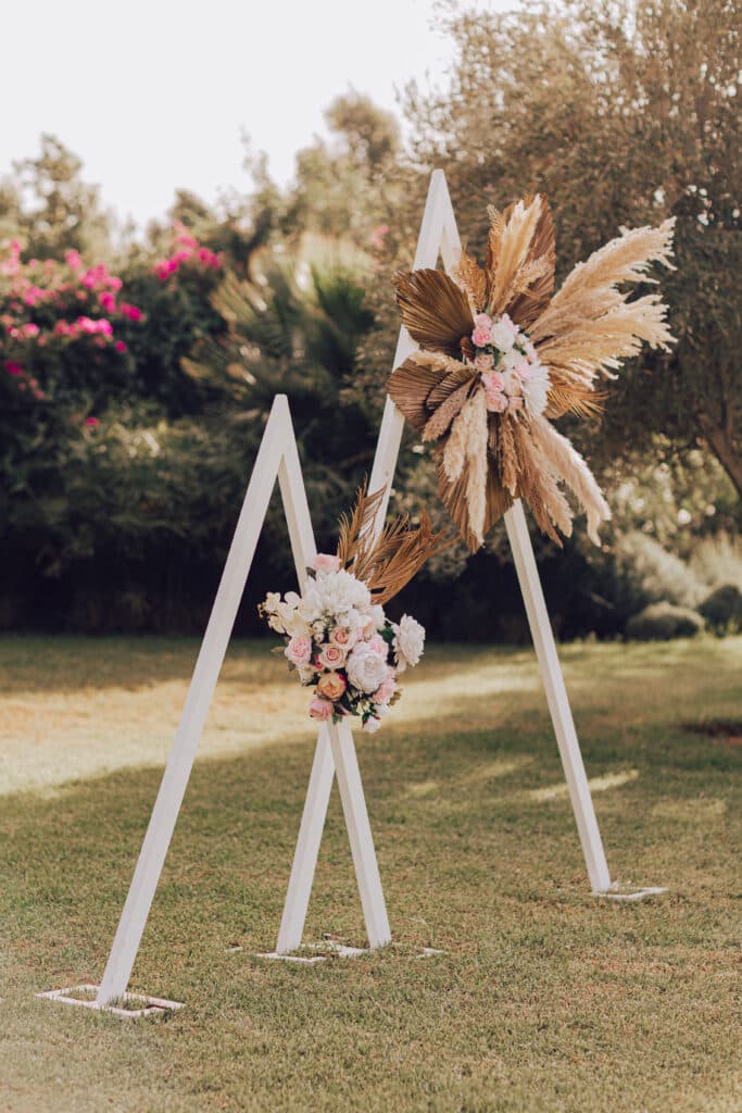 An outdoor wedding ceremony setting framed by palms