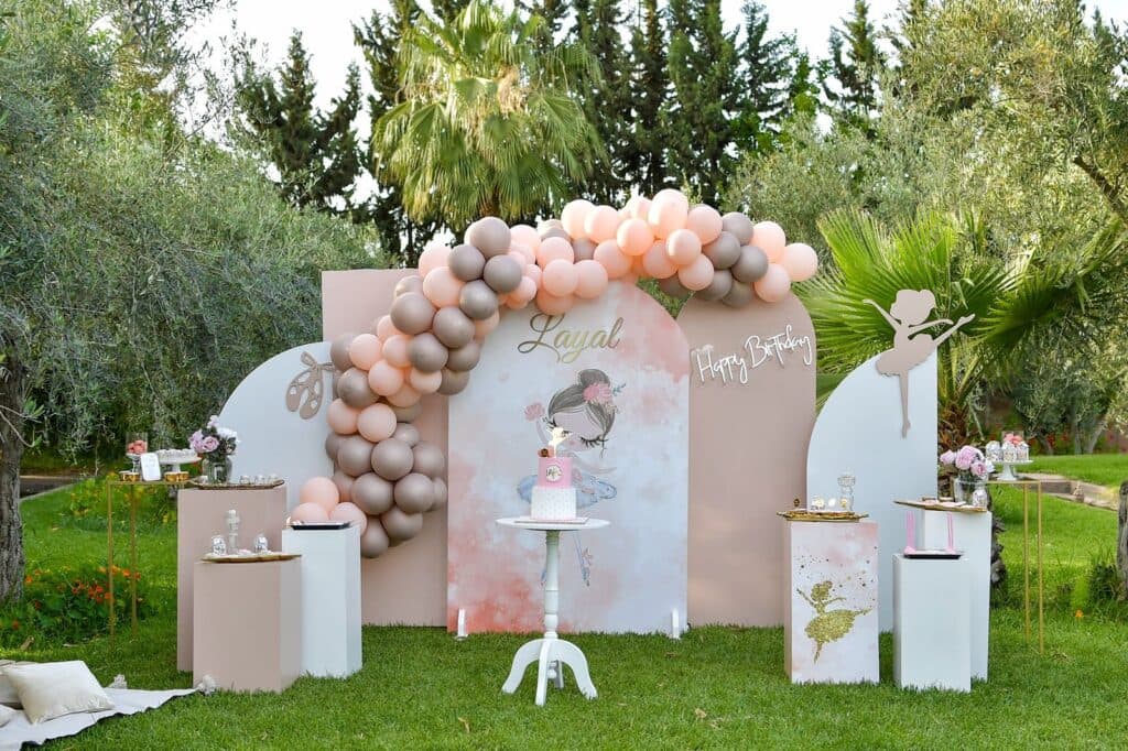 An outdoor birthday backdrop with fresh florals