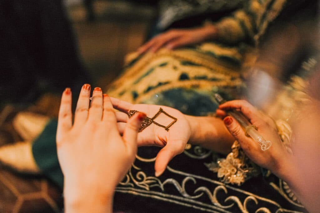 A hand decorated with henna for the celebration