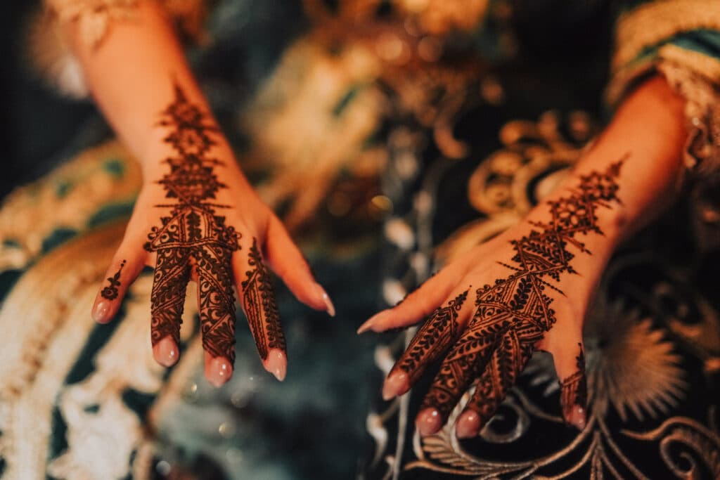 Fine henna patterns on a hand during a celebration